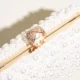 Close-up of jeweled ring clasp and pearl-look beading on box clutch