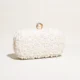 White rounded pearl-look beaded clutch with gold-tone ring clasp