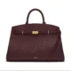 Burgundy top-handle tote with gold-tone front hardware