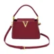 Red trapeze shoulder bag with gold-tone V-shaped front detail