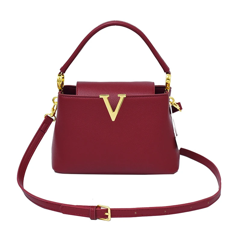 Red trapeze shoulder bag with gold-tone V-shaped front detail