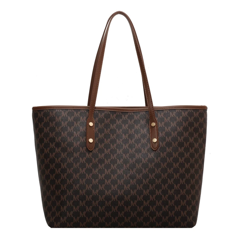 Dark patterned shoulder tote with brown handles, front view