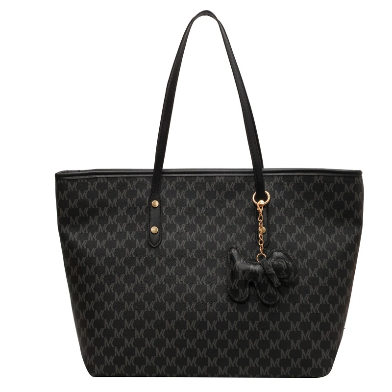 Black all-over pattern tote with black handles and charm