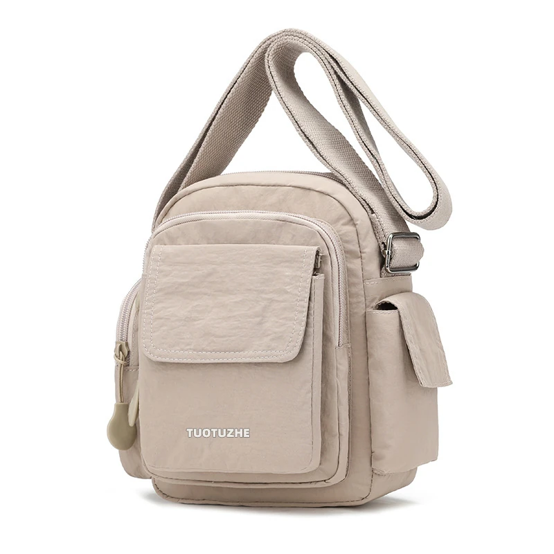 Beige multi-pocket utility crossbody bag with front flap and side pouches